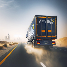 News article image: An Astell branded lorry travelling through an arid landscape towards a city